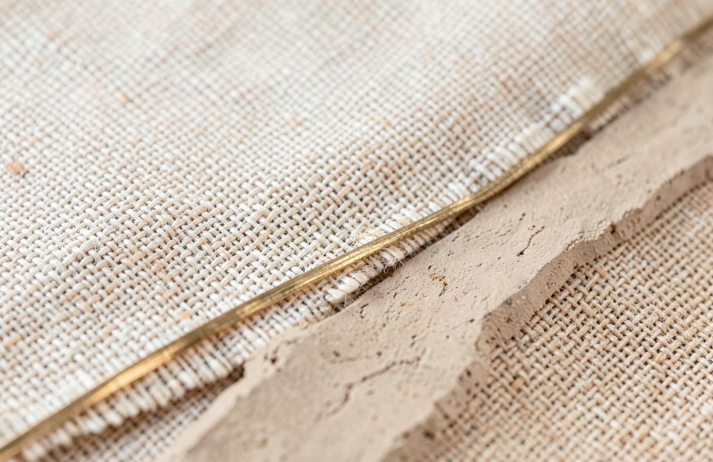 Woven linen, clay and brass textured surface detail